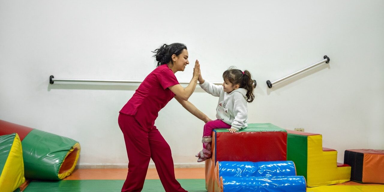 A child and parent playing at ABA therapy clinic